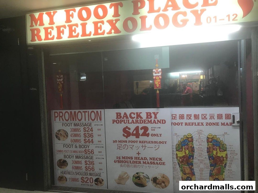 Shop front of 'My Foot Place Reflexology' with promotions and a foot reflexology chart.