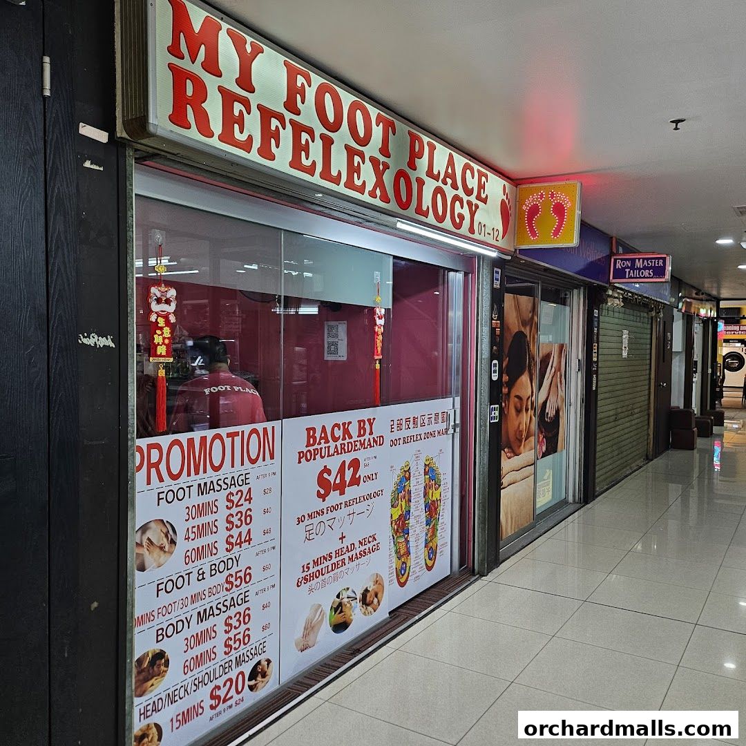 Shop front of 'My Foot Place Reflexology' with promotions and services displayed.