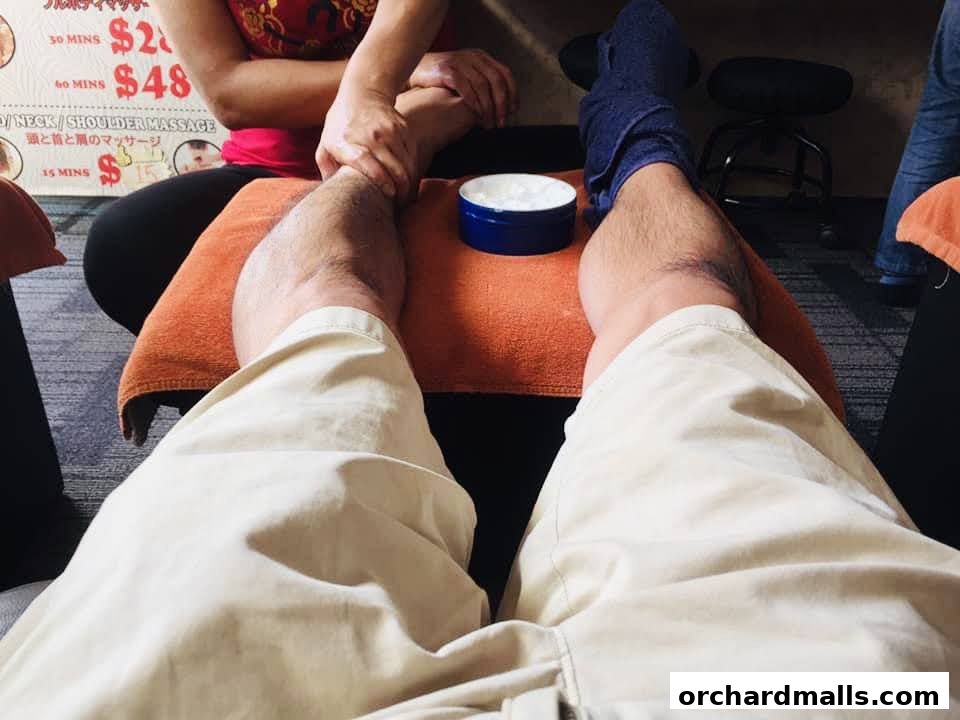 A person receiving a foot massage at My Foot Place Reflexology.