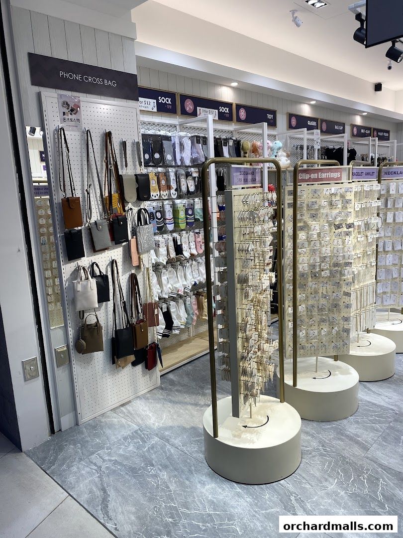 A retail shop interior displaying phone cross bags, socks, and clip-on earrings.