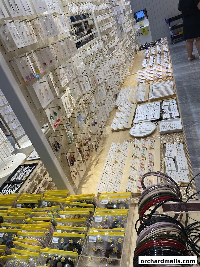 A well-stocked shop displaying a wide variety of fashion accessories, including earrings, necklaces, and hairbands.