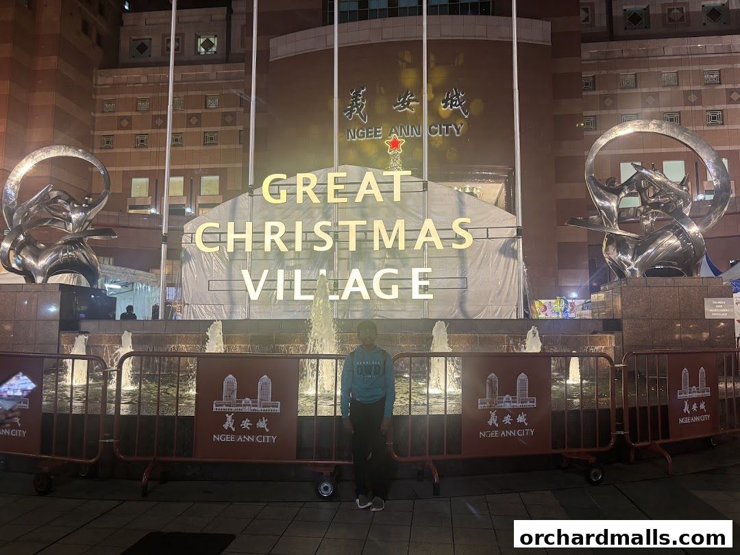 A person stands in front of Ngee Ann City during a Great Christmas Village event.