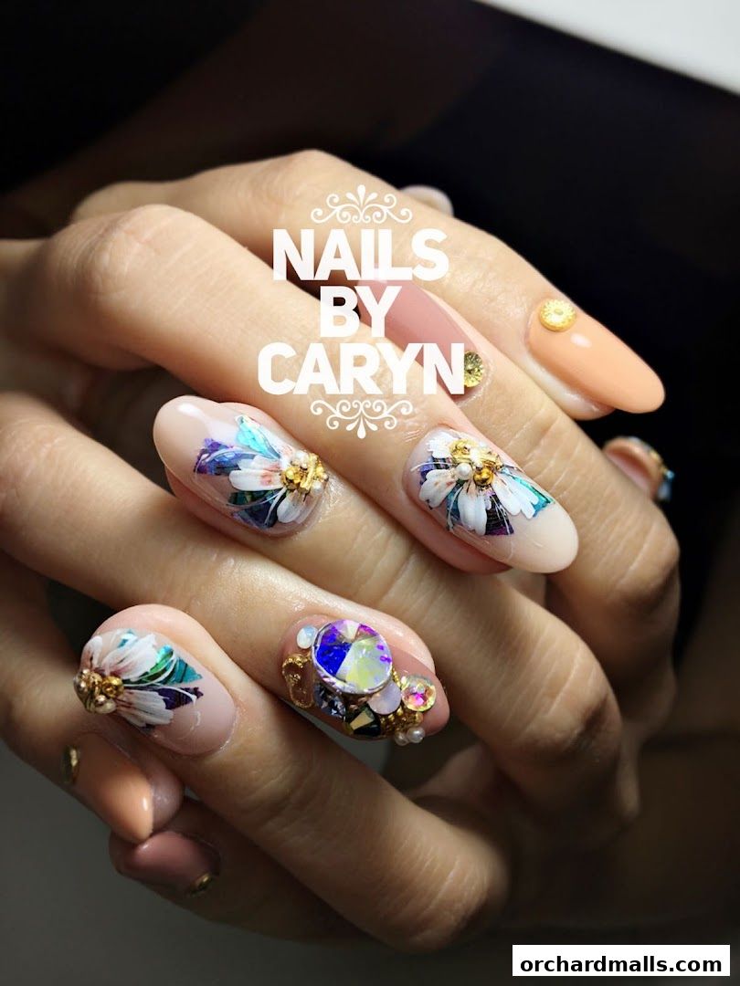 Close-up of hands with intricately designed floral and gem-embellished nails.