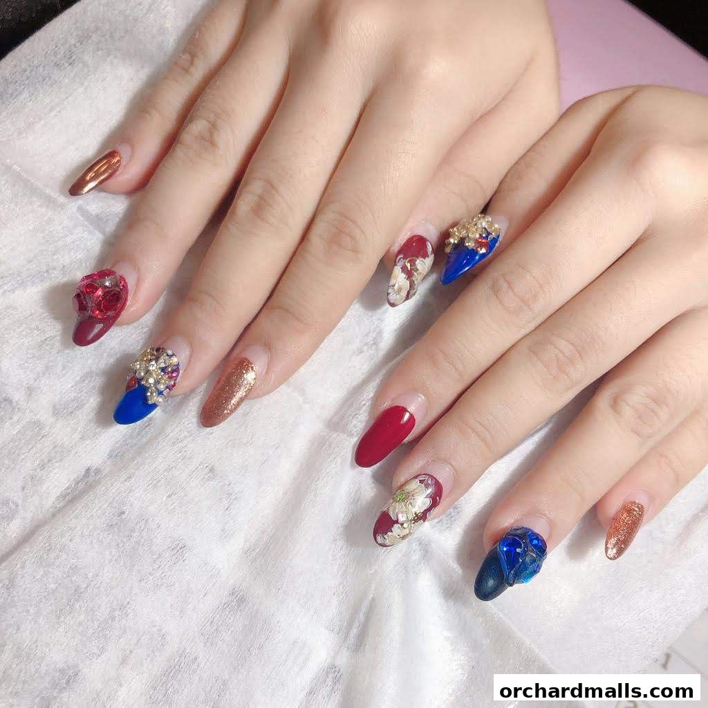 Close-up of hands with elaborately decorated, long artificial nails.