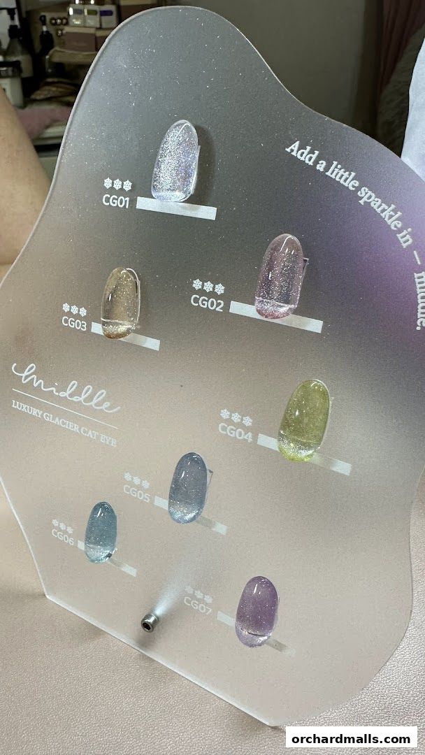 Display of various glittery nail polish colors with codes and brand name.