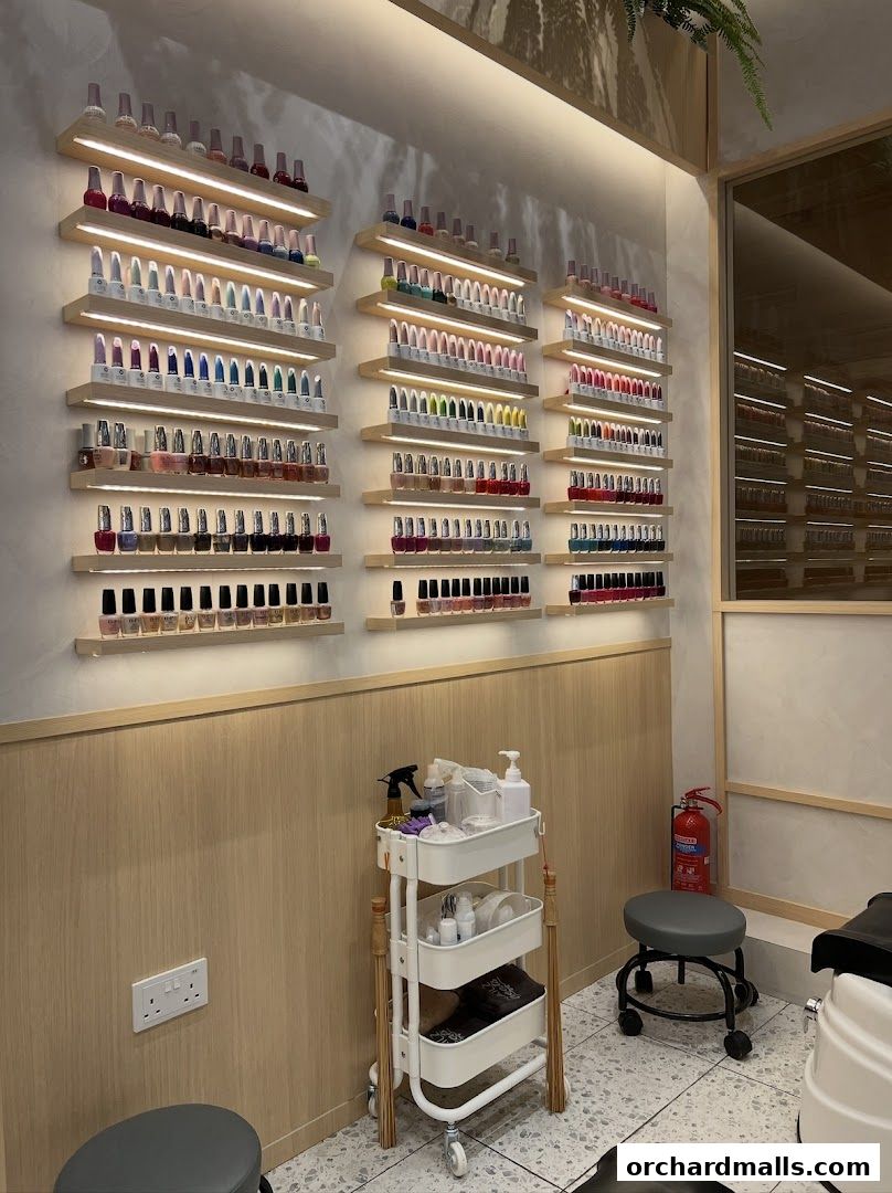 Interior shot of a nail salon with shelves displaying a wide variety of nail polish colors.