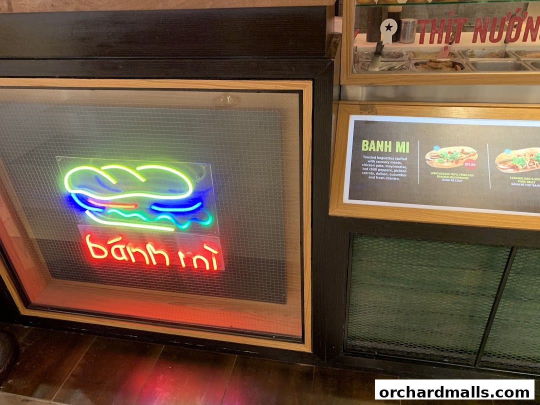 Neon sign for 'Banh Mi' and a menu board displaying Vietnamese sandwiches.