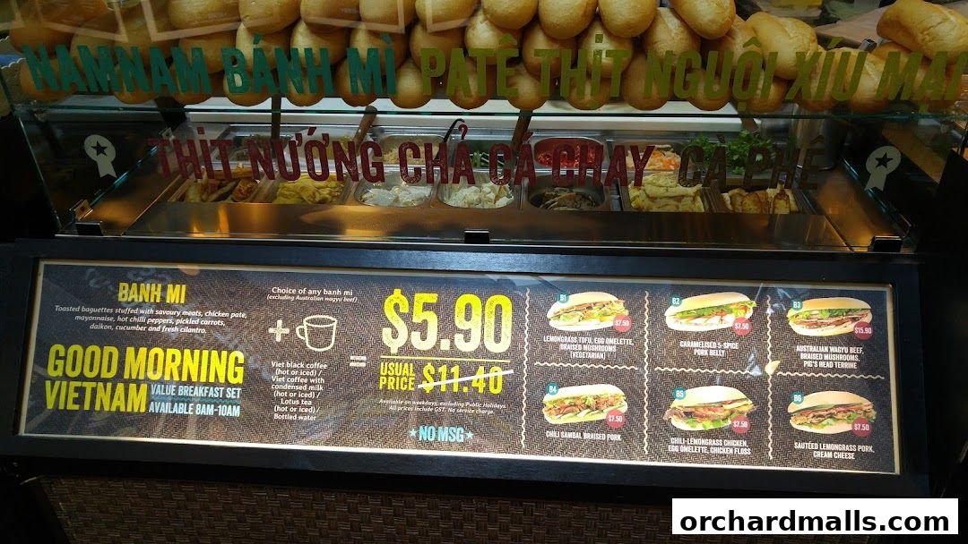A display of Vietnamese banh mi sandwiches with various fillings and prices.