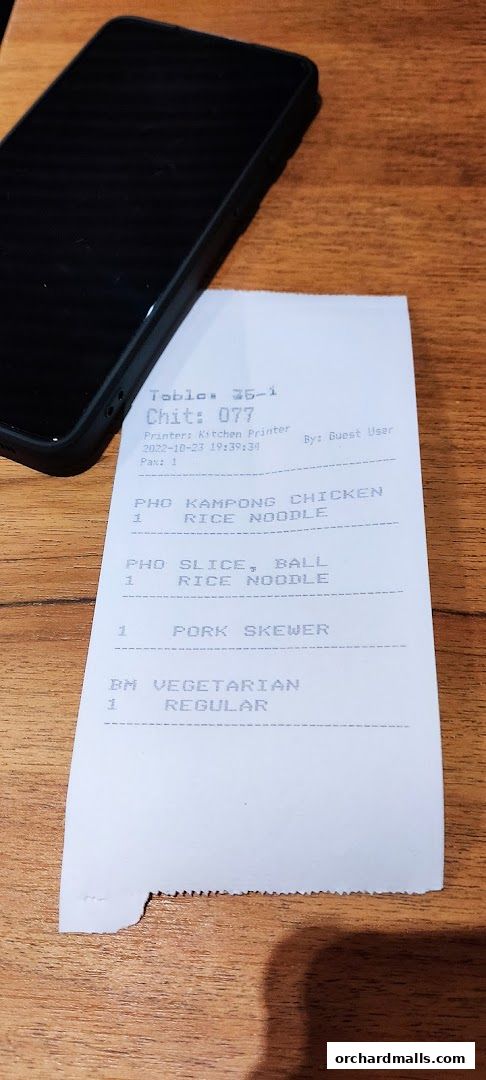 A receipt from NamNam Wheelock Place showing food orders and table information.