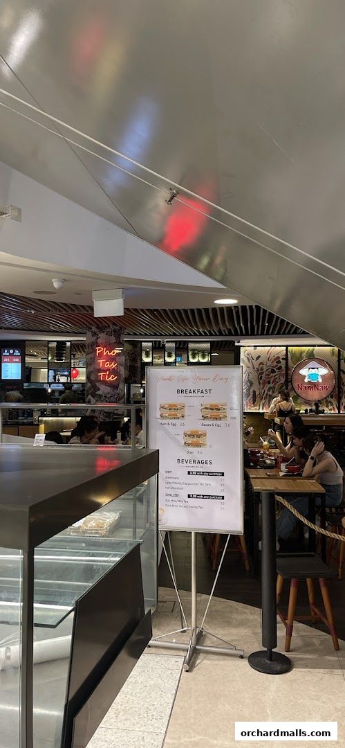 A menu board displays breakfast and beverage options at NamNam Wheelock Place.