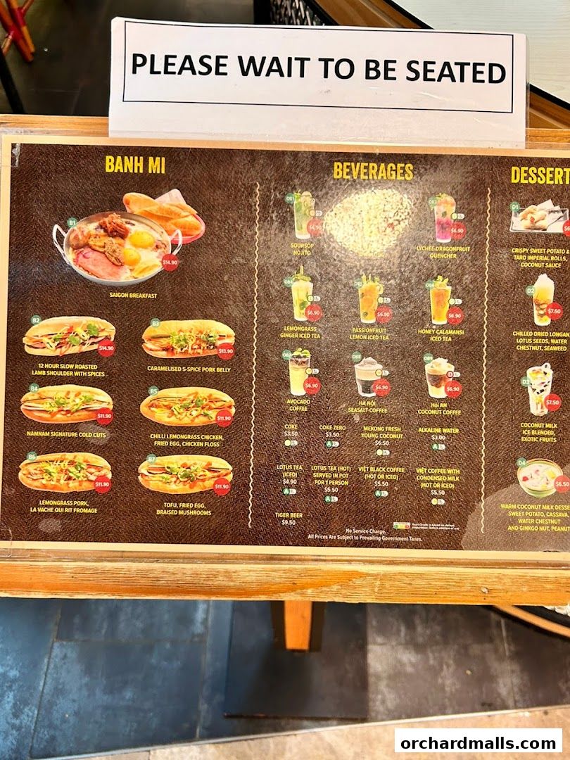A menu board displaying Banh Mi, Beverages, and Desserts with prices.
