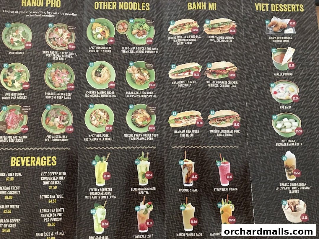 A menu from NamNam Wheelock Place featuring Vietnamese dishes like Pho, Banh Mi, and desserts.