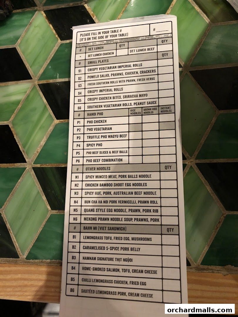 A menu from NamNam Wheelock Place with Vietnamese dishes like Pho and Banh Mi.