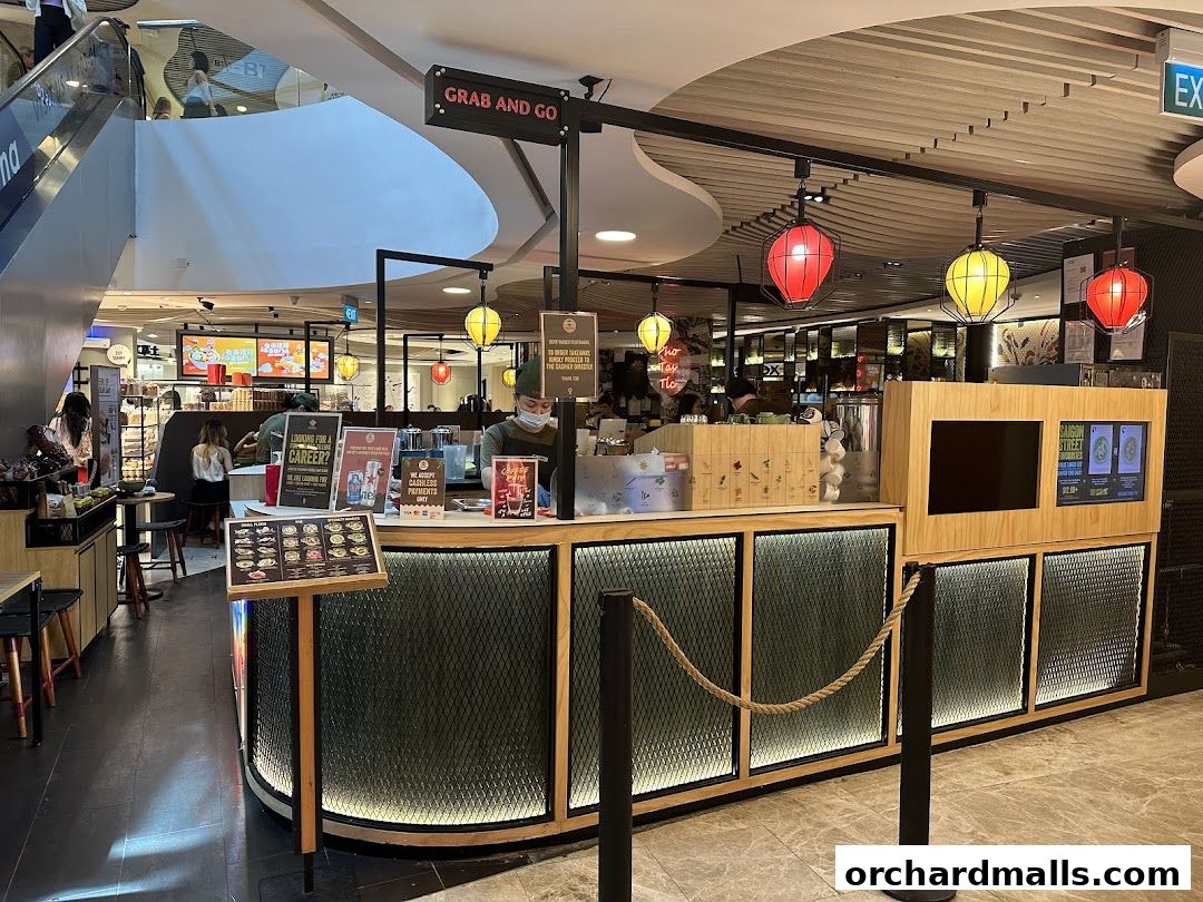 NamNam Wheelock Place is a grab-and-go eatery with a modern counter and vibrant lanterns.