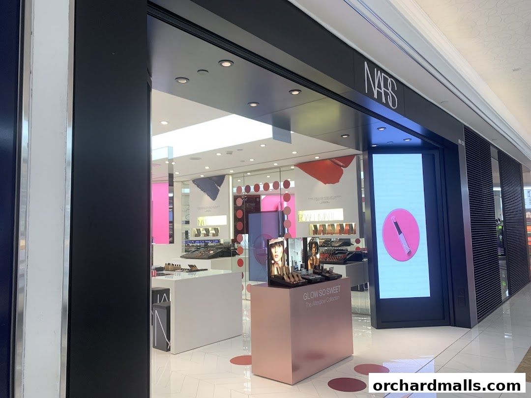 The NARS cosmetics store entrance with displays of makeup and a digital screen.