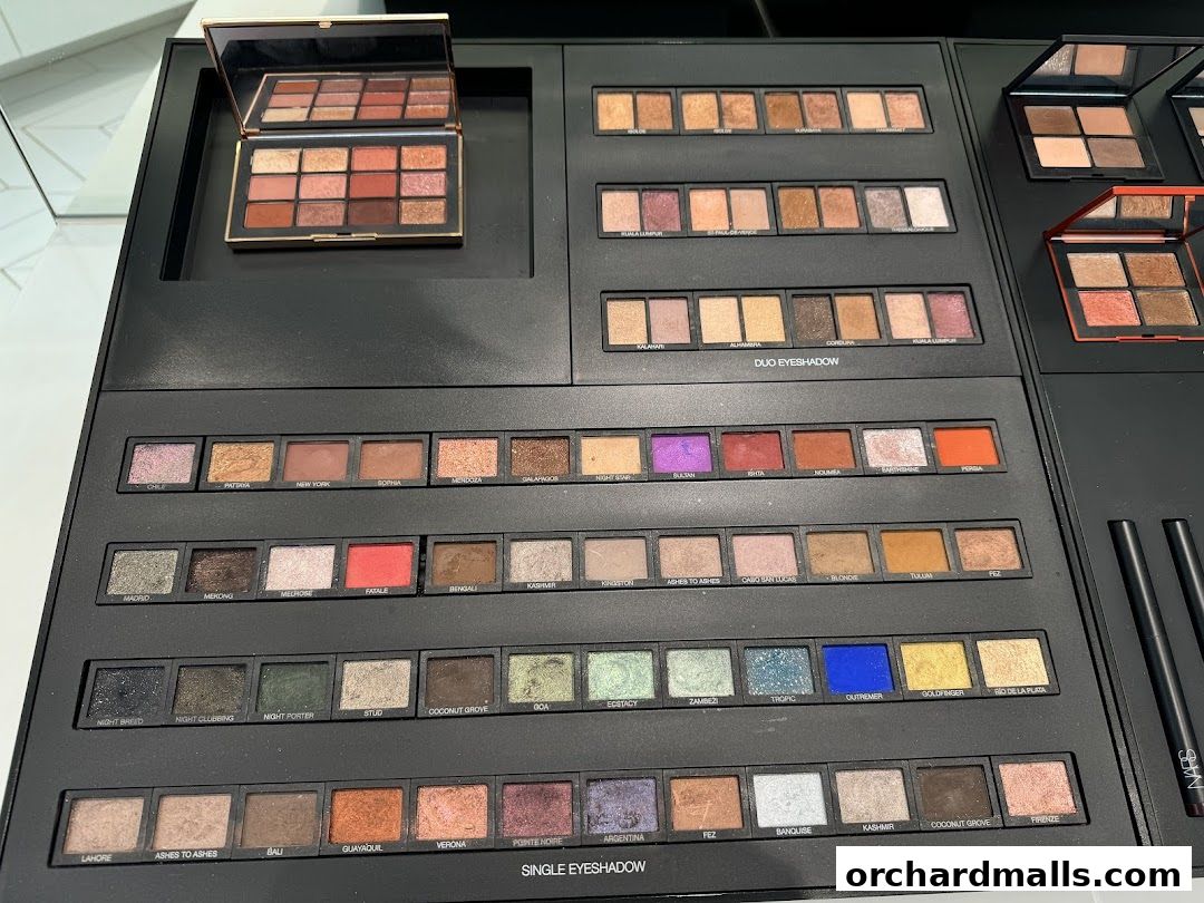 A display of NARS eyeshadow palettes and individual eyeshadows in various shades.