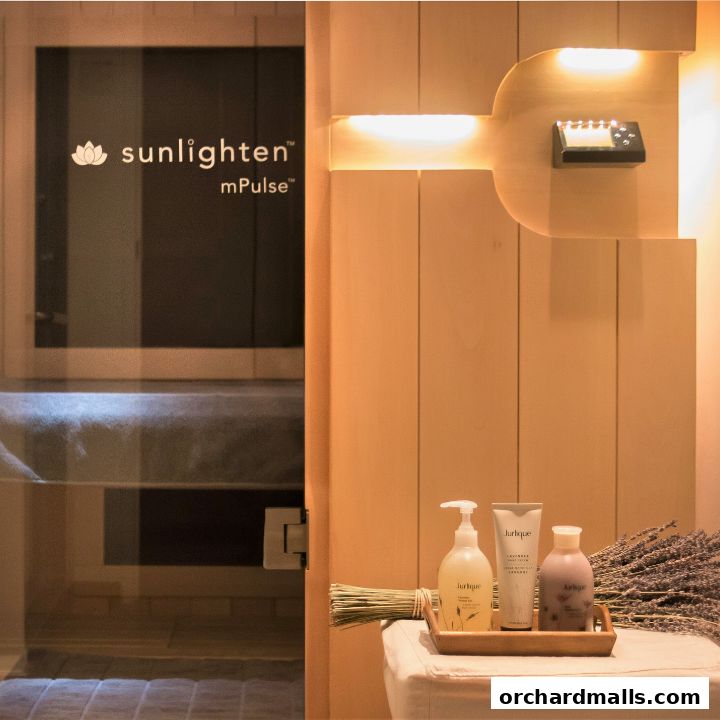 Interior of a spa with a sauna entrance and Jurlique products on display.