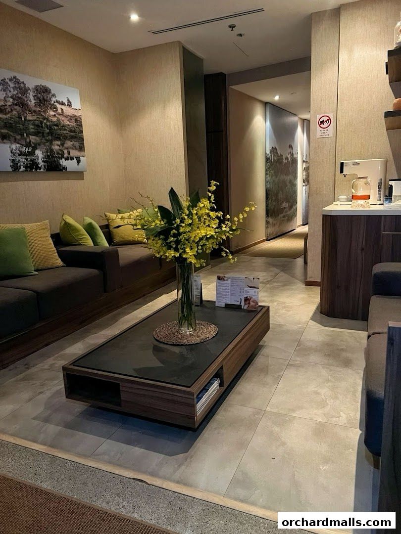 Interior waiting area of a spa with comfortable seating and floral arrangements.