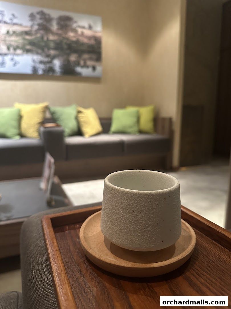 A serene spa waiting area with a cup of tea on a wooden tray.