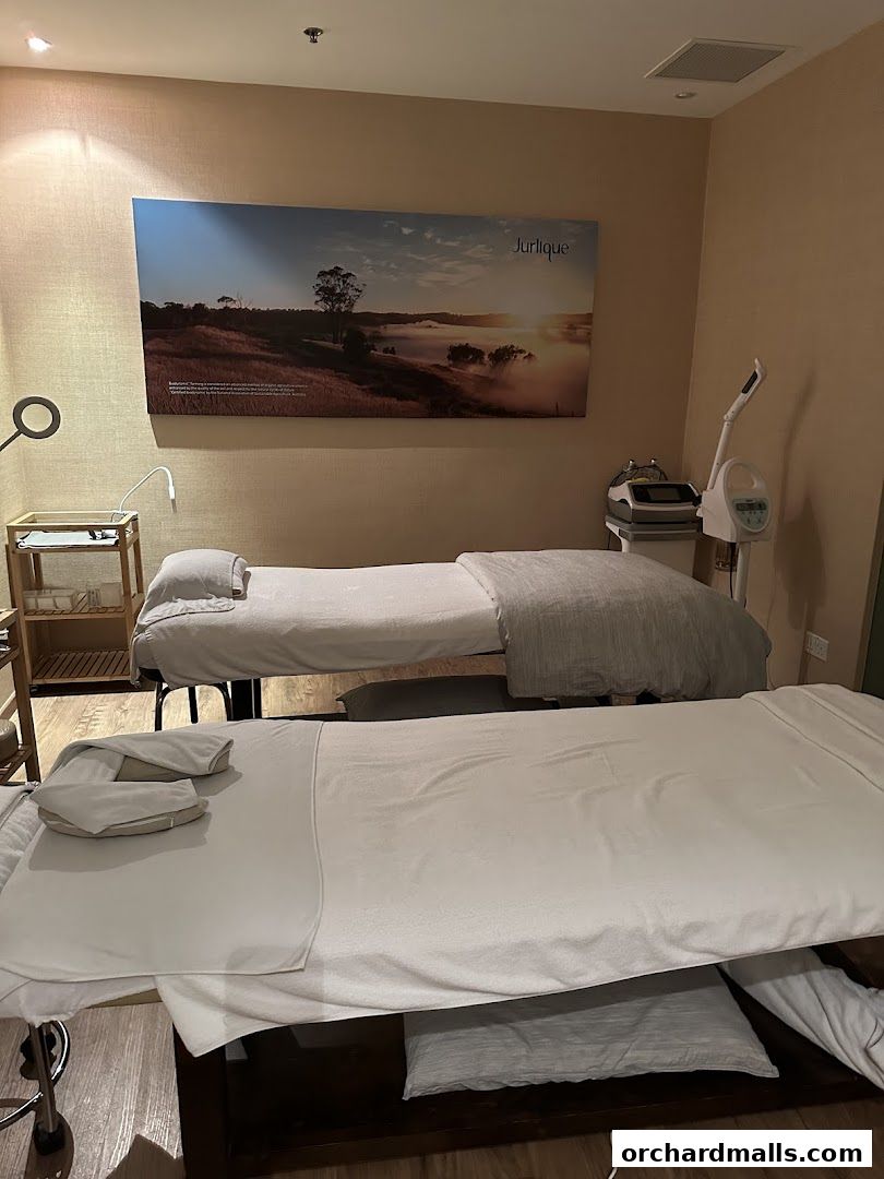 Two massage beds are set up in a serene spa room with calming decor.