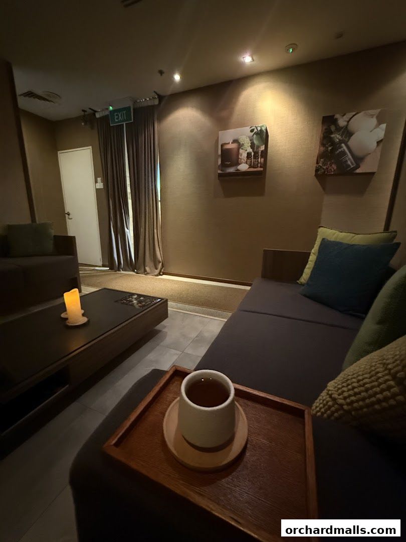 A serene waiting area in a spa with comfortable seating and a cup of tea.