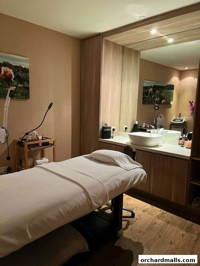 A treatment room at Natures Spa with a massage bed, sink, and spa equipment.