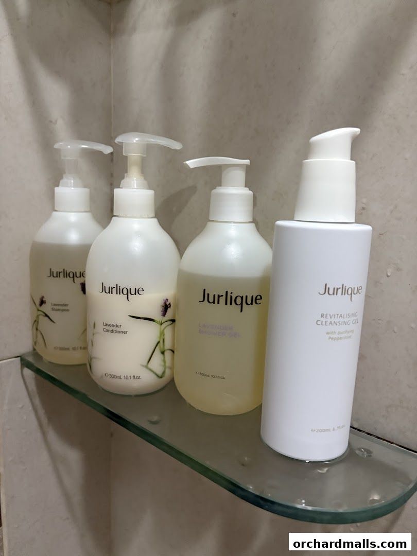 Four Jurlique skincare products displayed on a glass shelf.