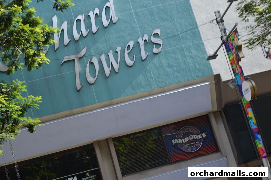 Exterior view of a building with 'chard Towers' signage and a 'Jamboree' sign visible.