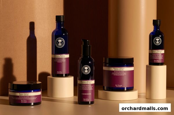 Neals Yard Remedies products displayed on pedestals against a textured background.