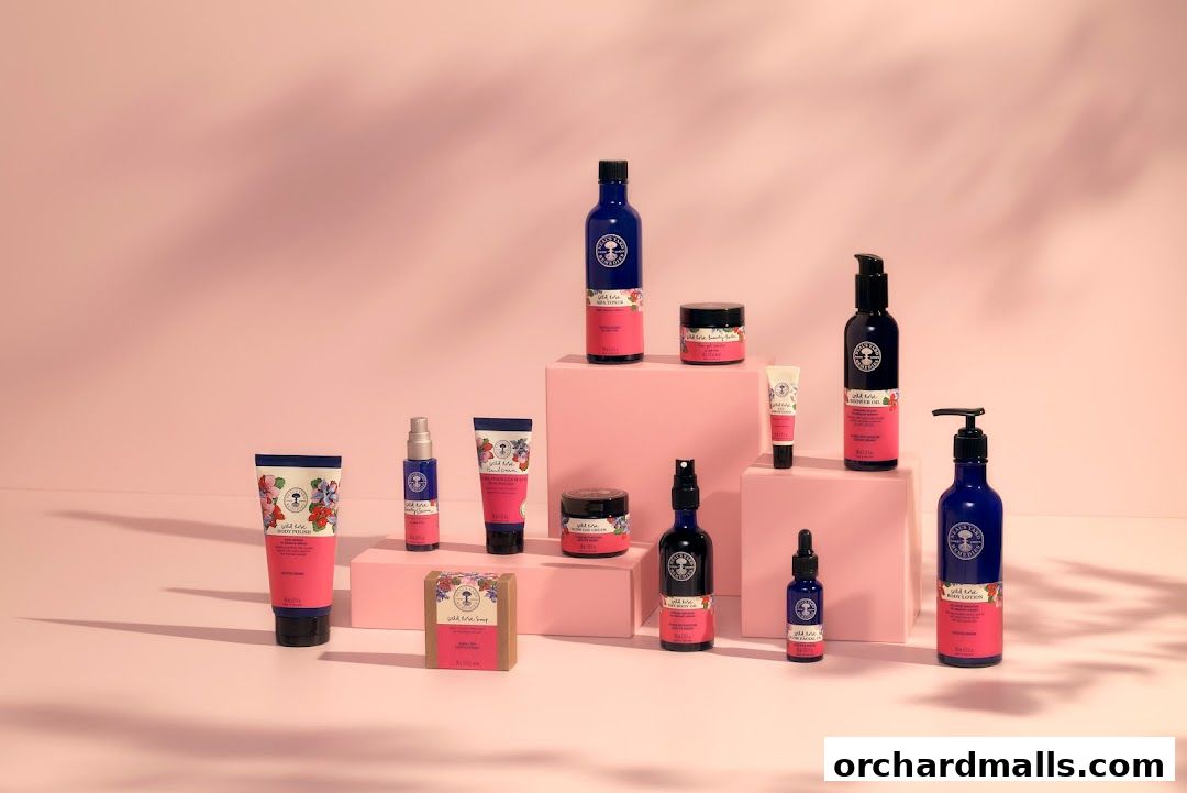A collection of Wild Rose beauty products from Neal's Yard Remedies arranged on pink pedestals.