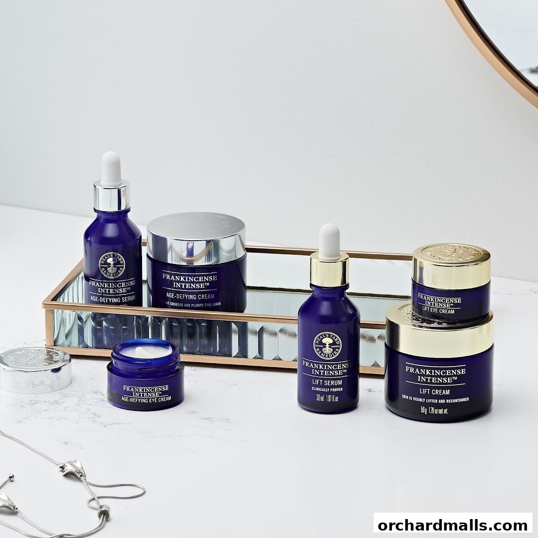A collection of Neal's Yard Remedies Frankincense Intense skincare products displayed on a mirrored tray.