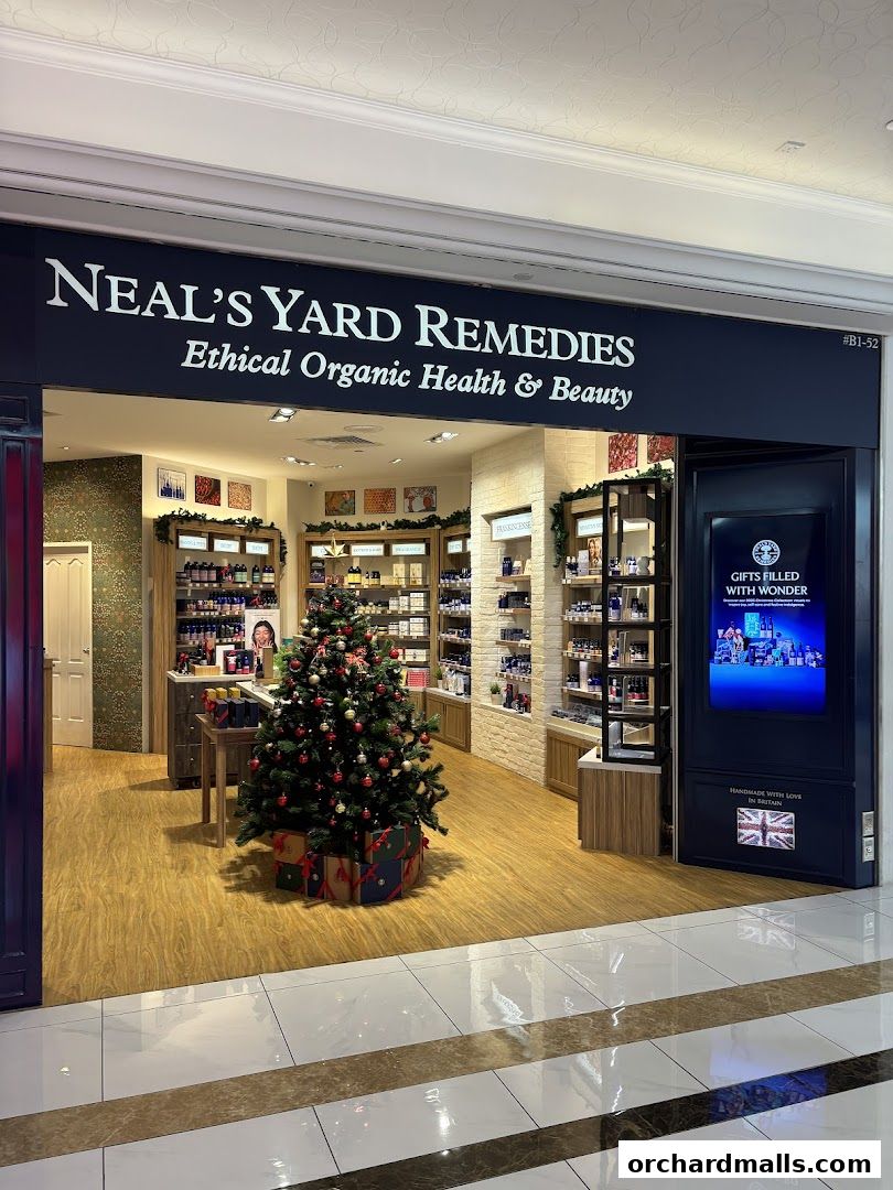 The exterior of Neal's Yard Remedies shop, decorated for Christmas with a tree and gifts.