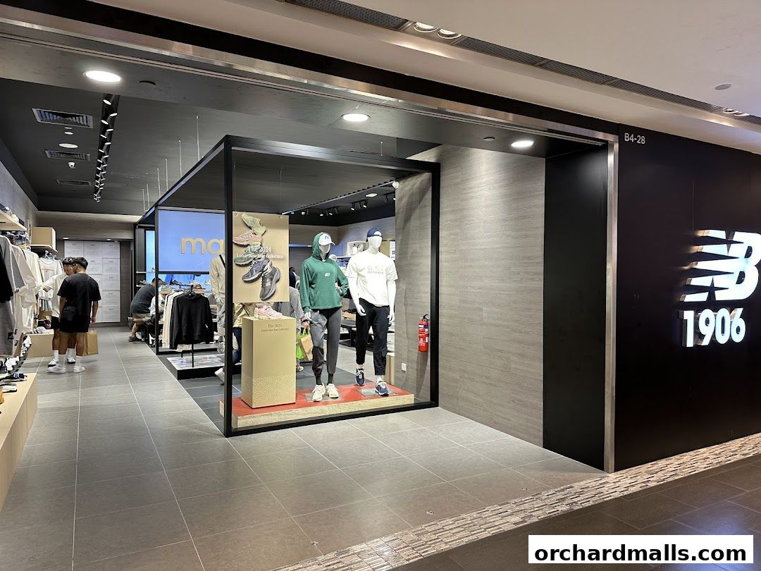 The New Balance store entrance with mannequins displaying apparel and footwear.
