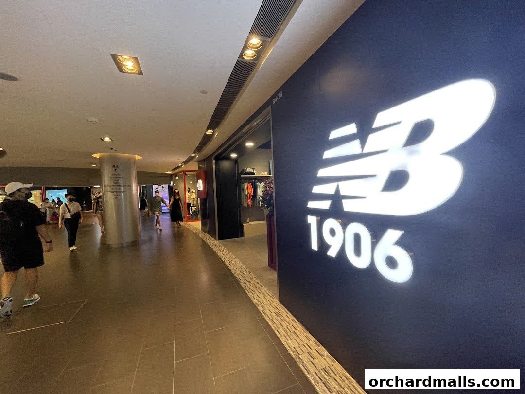 The New Balance 1906 store entrance with its prominent logo and display of merchandise.