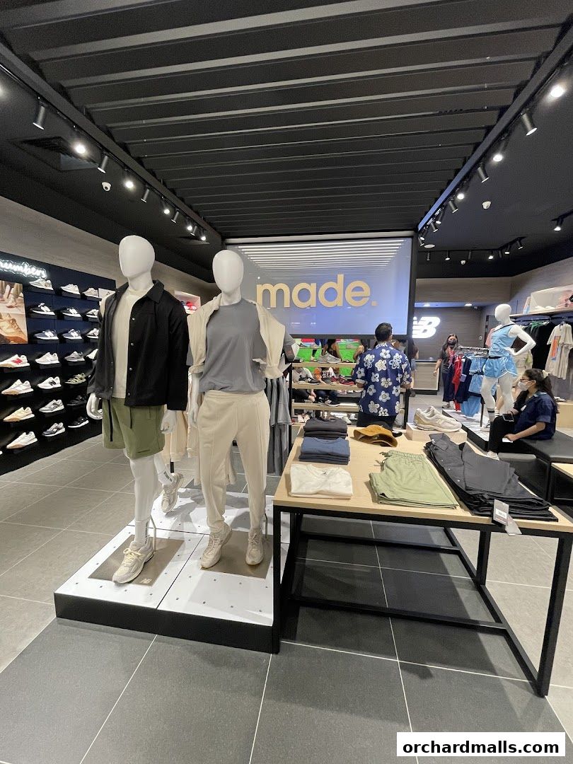 Interior of a New Balance store with mannequins displaying apparel and shoes.