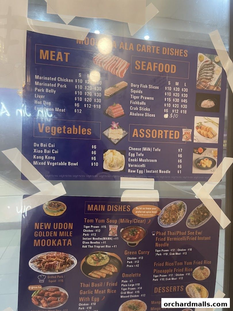A menu board for New Udon Mookata Thai Food, featuring meat, seafood, vegetables, and main dishes.