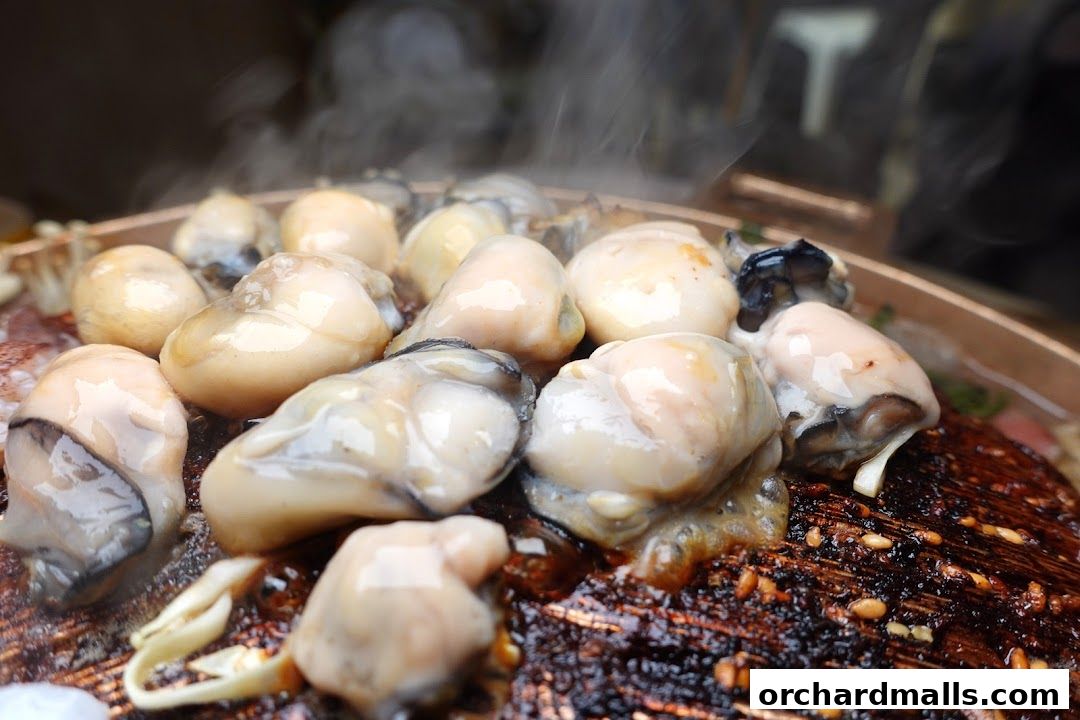 Steaming fresh oysters being cooked on a grill, a delicious seafood dish.