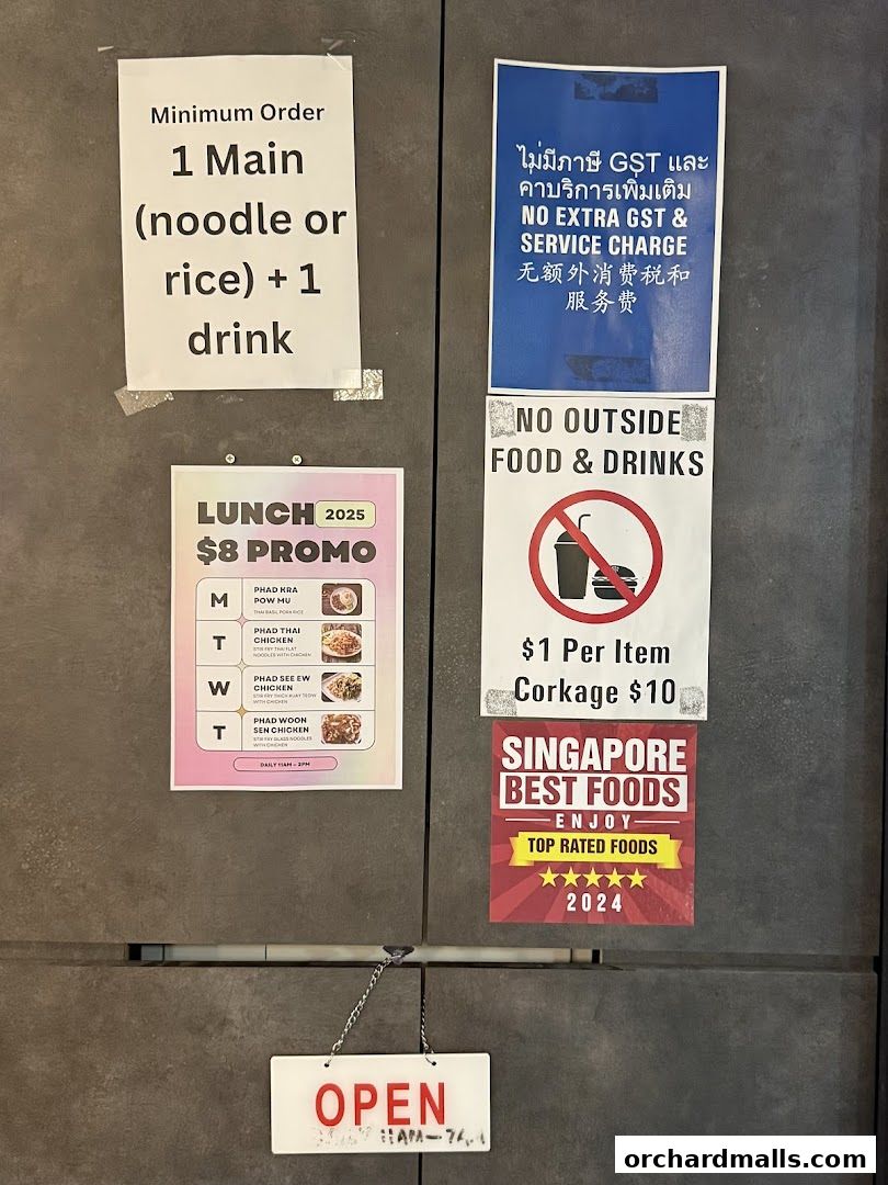 Signs on a wall including a lunch promo, minimum order, and no outside food policy.