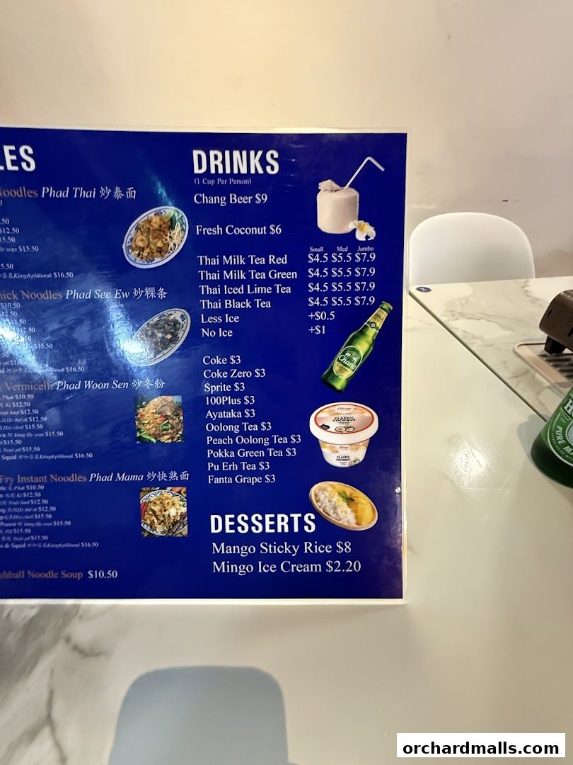 A menu board for New Udon Mookata Thai Food, featuring drinks and desserts.