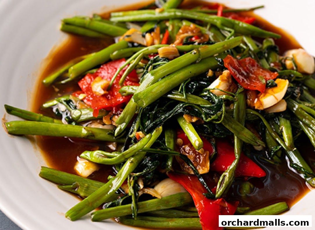 A close-up shot of a delicious stir-fried water spinach dish with chili and garlic.