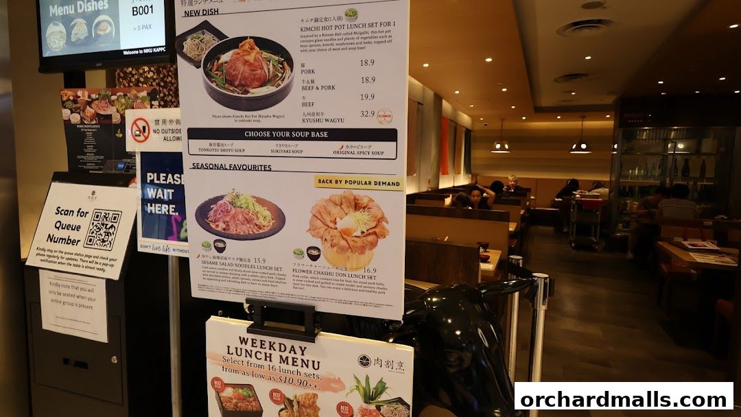 A menu board displays various lunch sets and hot pot options at Niku Kappo.