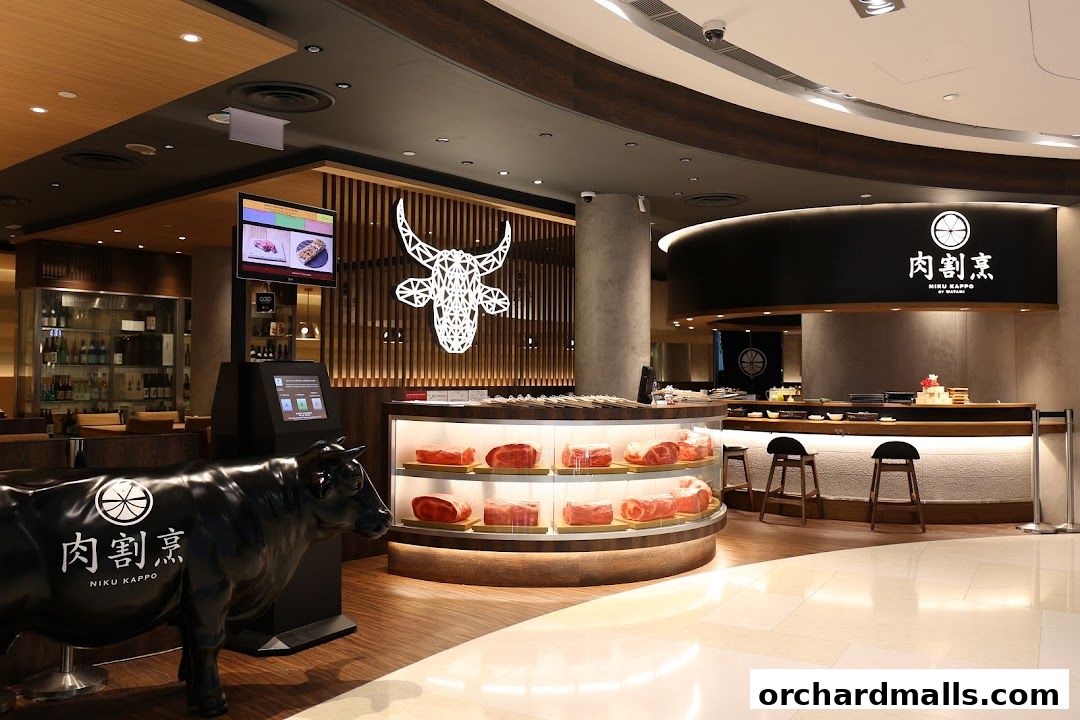 Interior view of Niku Kappo restaurant with a display of raw meat and a prominent cow statue.