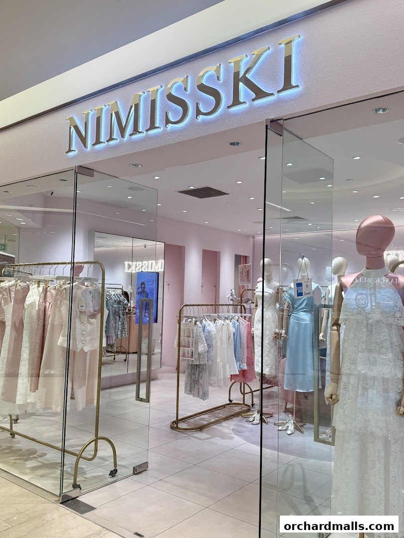 The entrance of NIMISSKI, a boutique showcasing elegant dresses and apparel on mannequins and racks.