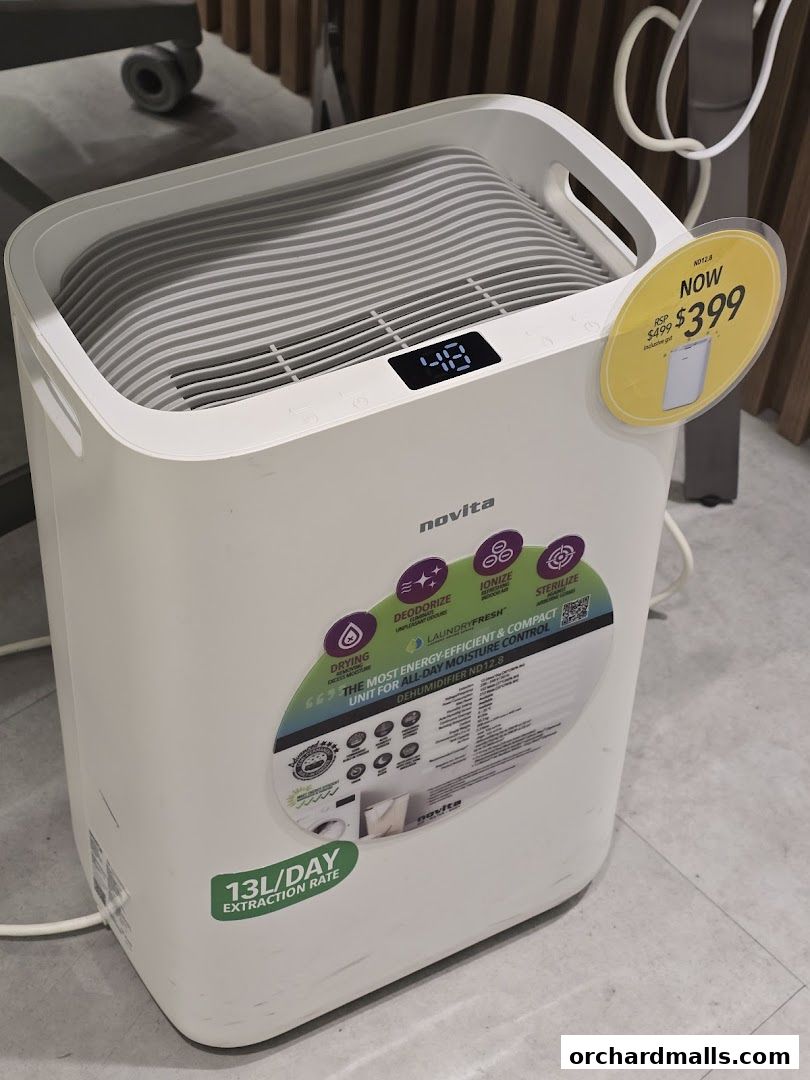 A Novita dehumidifier with a digital display and a price tag showing a sale.