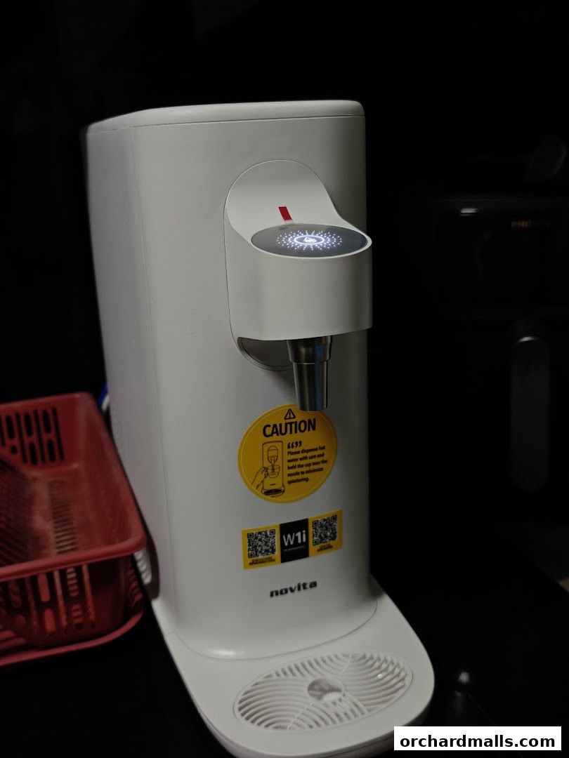 A white Novita water dispenser with a caution sticker and QR codes.