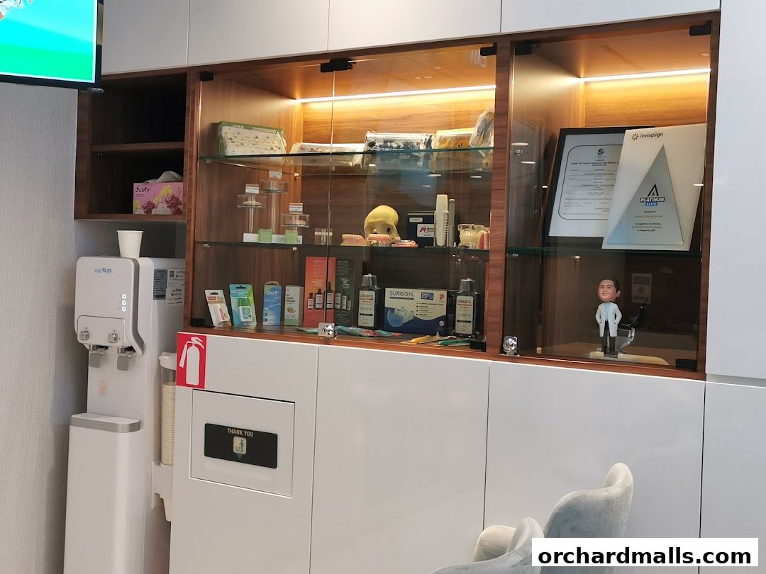 Interior shot of a dental clinic with display cases, water dispenser, and seating.