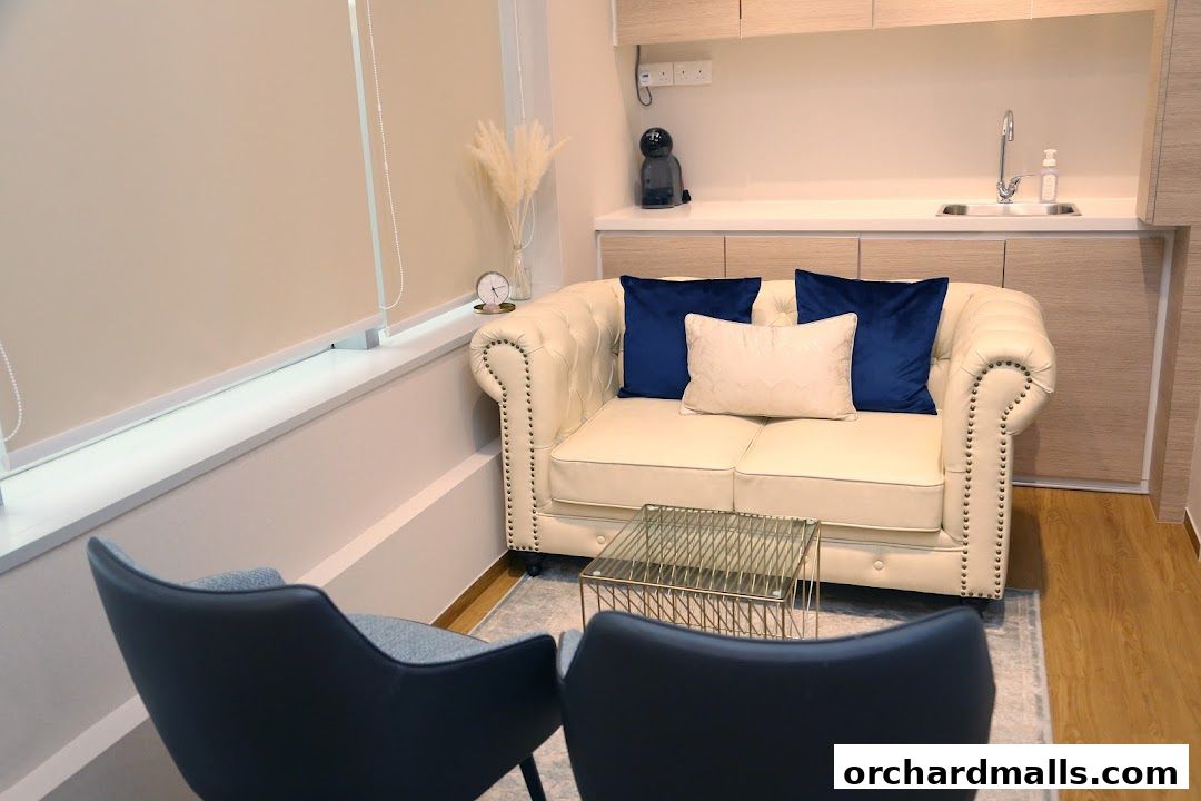 A comfortable waiting area with a chesterfield sofa, accent chairs, and a small coffee table.