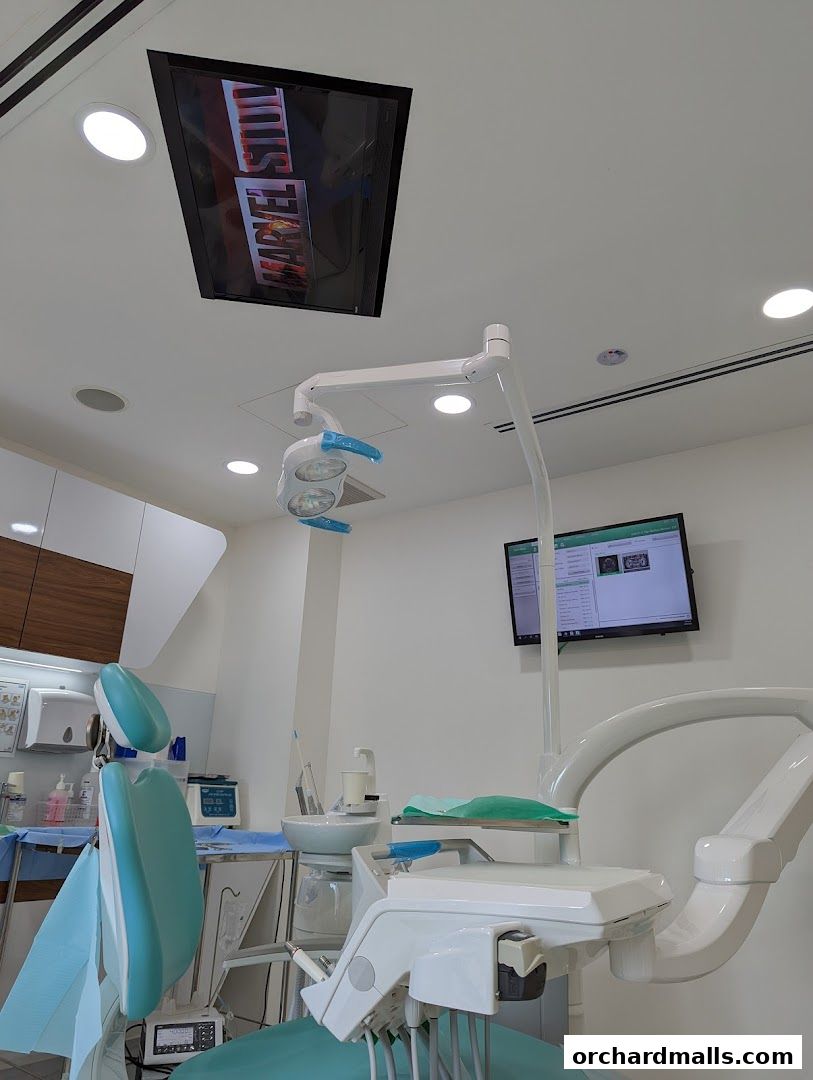 Interior of a modern dental clinic with a dental chair and equipment.