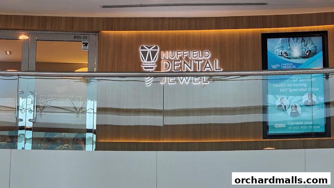 Exterior view of Nuffield Dental Jewel, showcasing its illuminated signage and contact information.