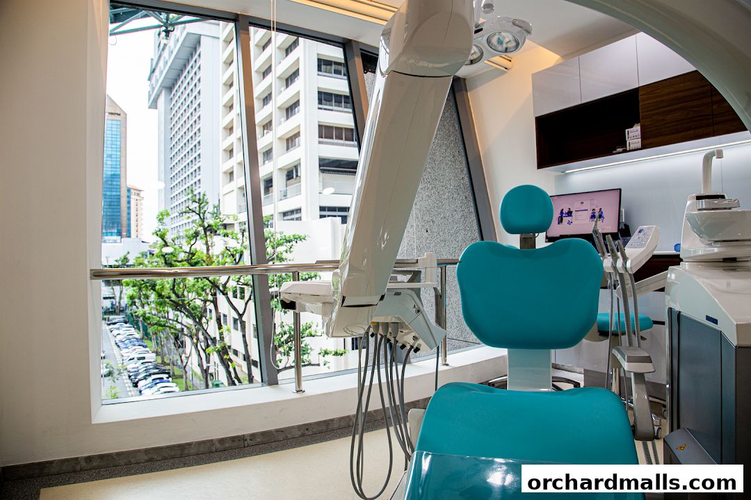 Interior of a modern dental clinic with a dental chair and equipment.